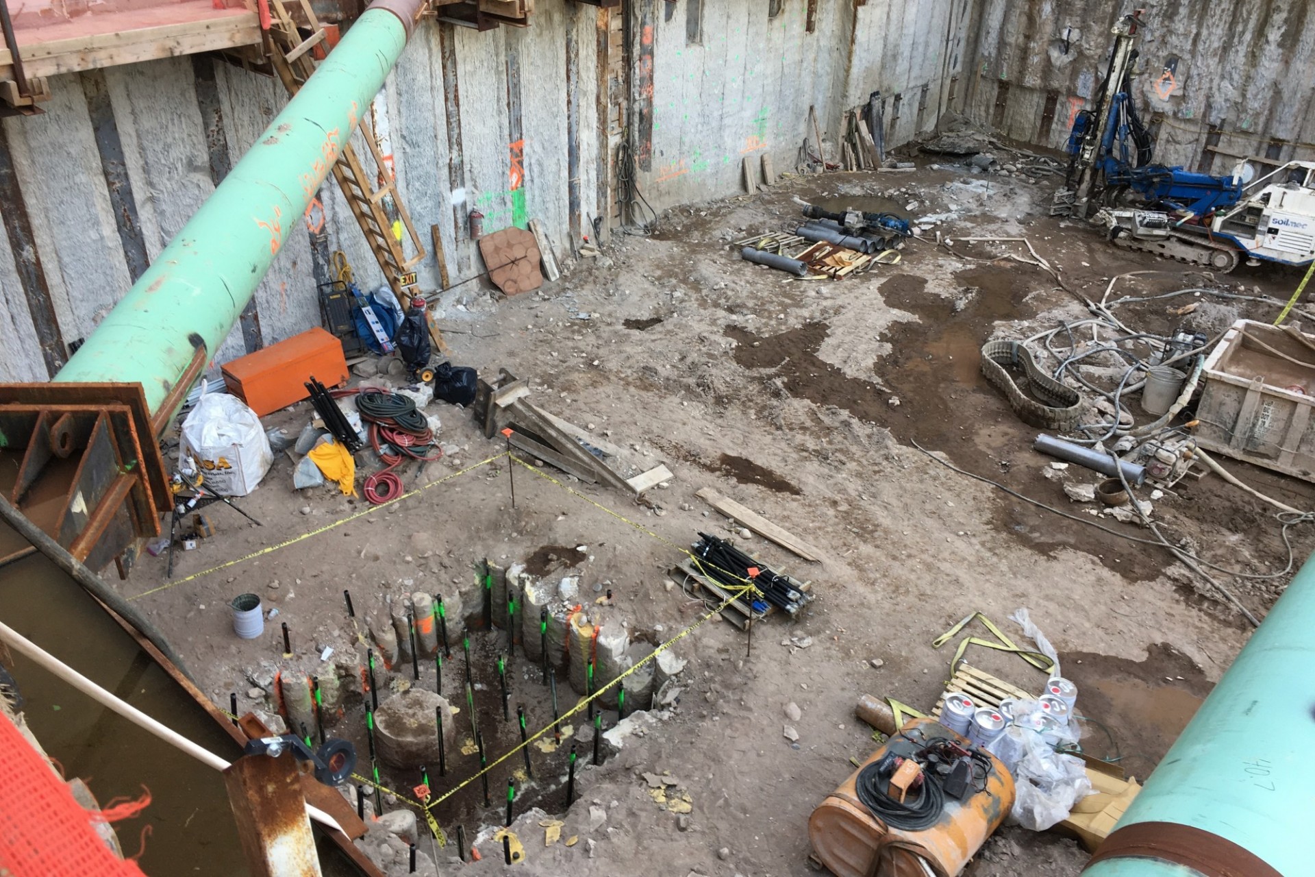 A view of the 600 W. 125th Street construction site with equipment and support pipes running across. Foundation work being performed on a construction site.  