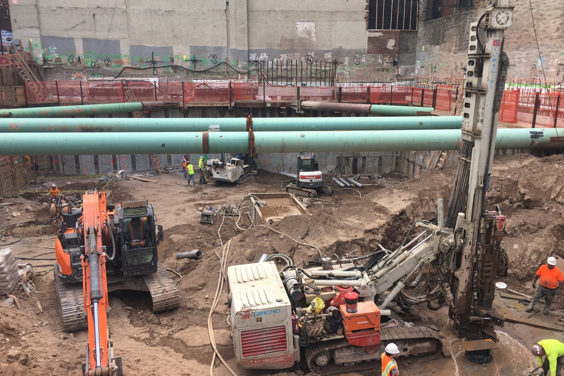 A view of the 600 W. 125th Street construction site with equipment and support pipes running across. Foundation work being performed on a construction site.  