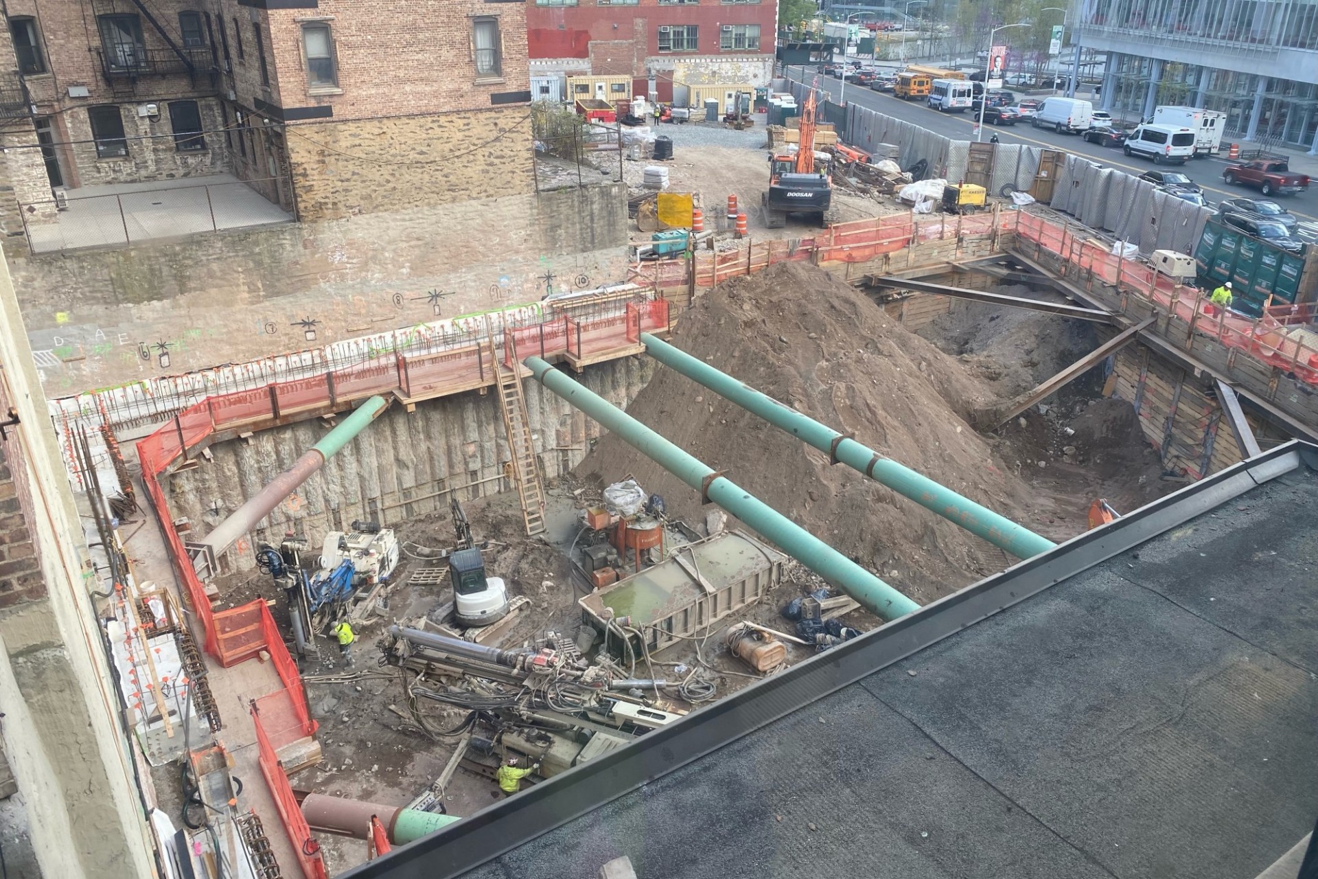 A view of the 600 W. 125th Street construction site with equipment and support pipes running across. Foundation work being performed on a construction site.  