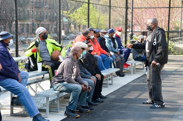 Photo Credit: NYC Parks / Daniel Avila people sitting in new bleachers at basketball court