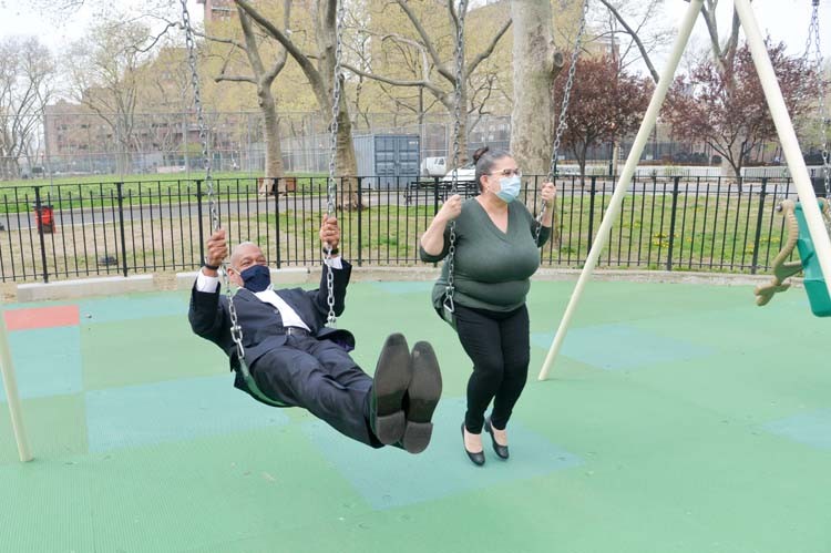 Photo Credit: NYC Parks / Daniel Avila Man and woman on swingset