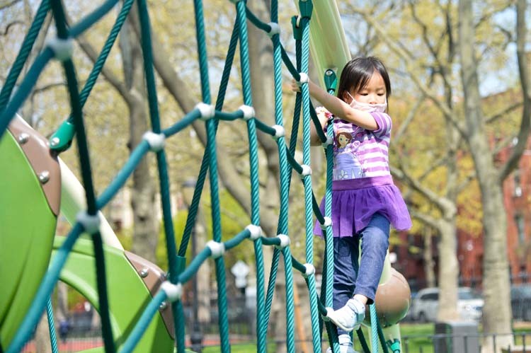 Girl on jungle gym