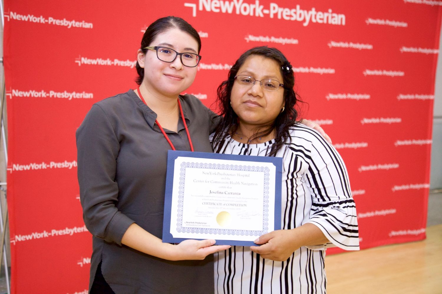 Sarah Cordero, pediatric community health worker, accompanied by the parent of a child in the CHW program receiving a certificate of completion Sarah Cordero, pediatric community health worker, accompanied by the parent of a child in the CHW program receiving a certificate of completion
