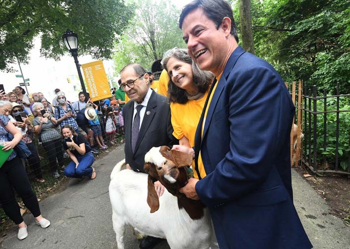 Photo Credit: Eileen Barroso people posing for photo with goat