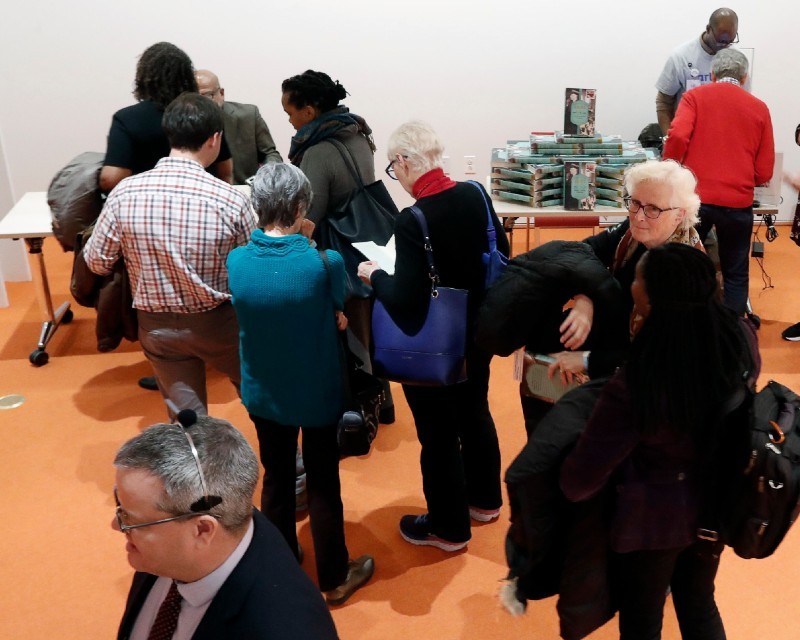 Eric K. Washington singing books after the lecture. Photo Credit: Lou Rocco Guests gather to get their book signed by author Eric K. Washington