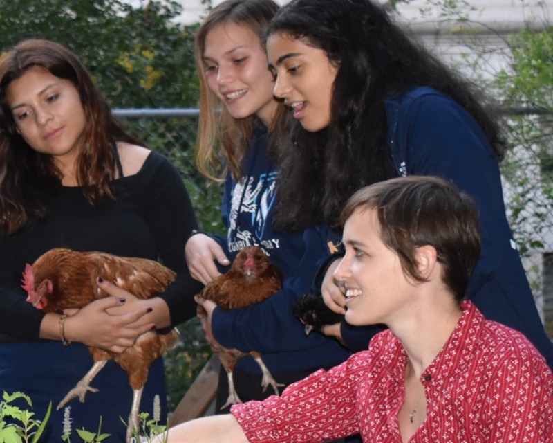 Meredith Hill (right) teaches a garden lesson to Columbia Secondary School students at the Columbia Secondary School community garden. Teacher and students in a community garden