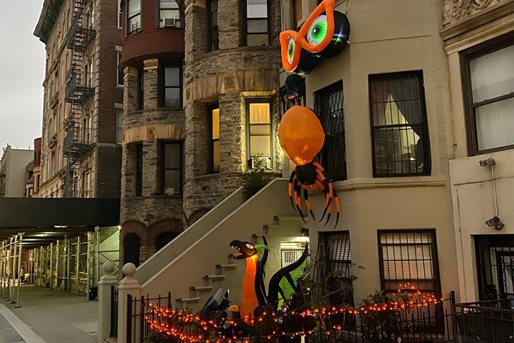Orange and black Halloween decorations on a town home in New York City