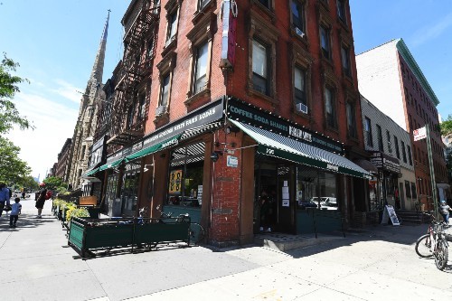 The restaurant Harlem Shake and the buildings next to it on both 124th Street and Malcolm X Blvd.