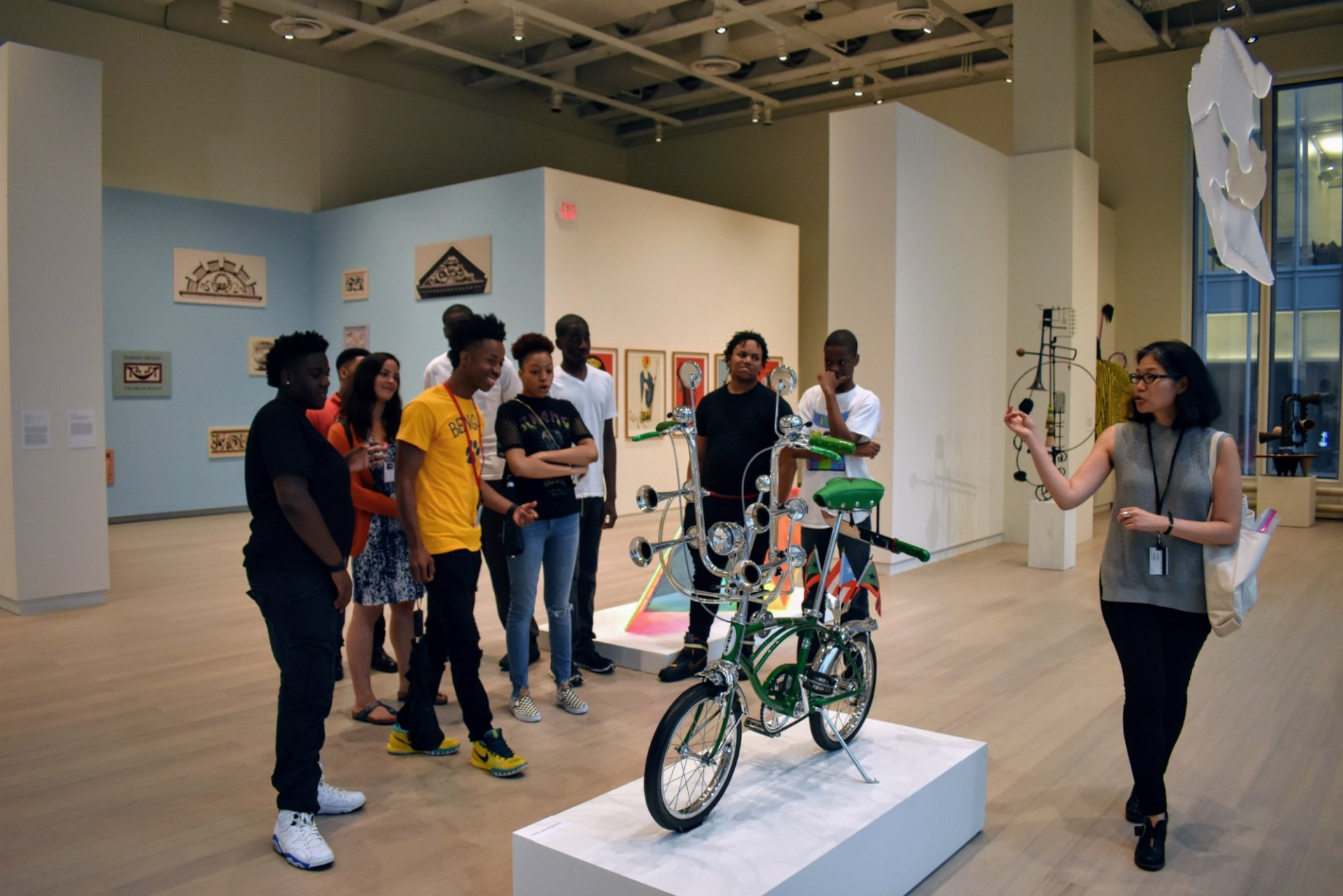 Manhattanville area youth from the Graham Windham’s SLAM program visit the Uptown triennial at the Wallach Art Gallery. The SLAM program provides long-term coaching and support for youth ages 15–23 as they transition into adulthood. Pictured: Jennifer Mock, Associate Director of Education and Public Programs at the Wallach, facilitates a tour of the gallery and explores concepts in art through a variety of exercises. Photo credit: Bashar Makhay