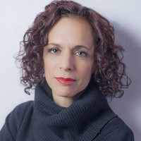 Judith Matloff, with curly hair and wear a black sweater.
