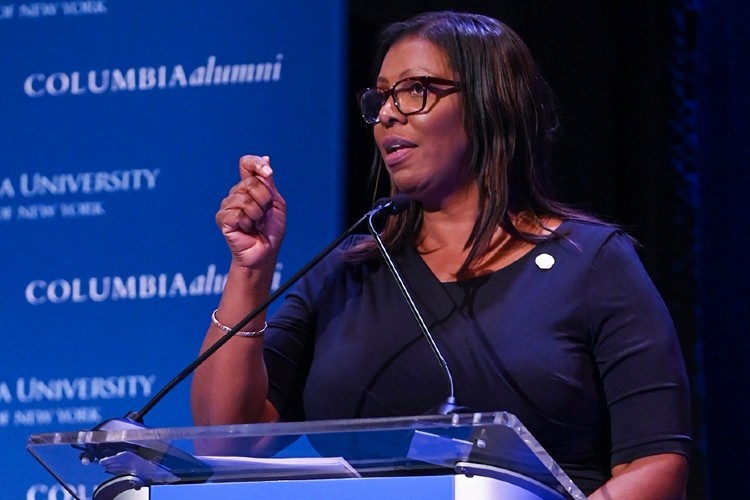 New York Attorney General Letitia James speaking at She Opened the Door 2020 on February 9th. Photo Credit: Diane Bondareff/Columbia University Letitia James speaking at a podium with arm raised.