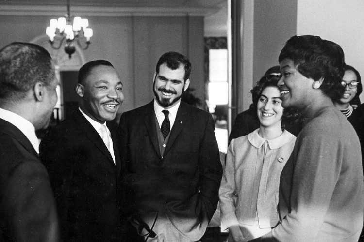 Martin Luther King, Jr., with "Owl" editor Wally Wood '88GS (center) and other students. Photo credit: Lawrence J. Howell Martin Luther King, Jr., with "Owl" editor Wally Wood '88GS (center) and other students. Photo by Lawrence J. Howell, courtesy of Wally Wood.