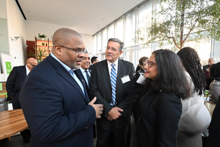 Shafik talks with an attendee at the Manhattanville Market breakfast reception. Photo credit: Eileen Barroso