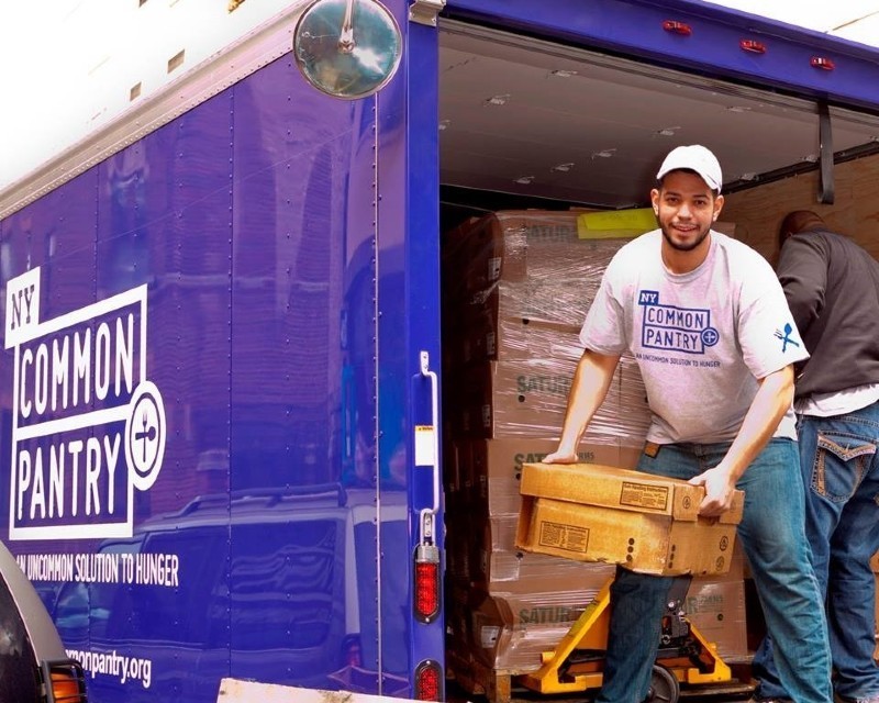 NY Common pantry worker offloading goods from a truck.