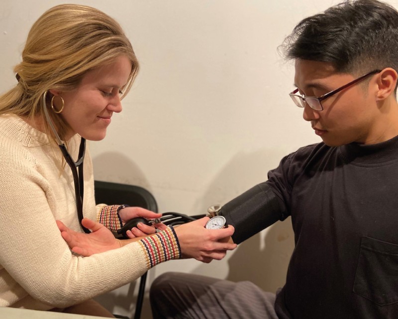 Medical student checking patients blood pressure.