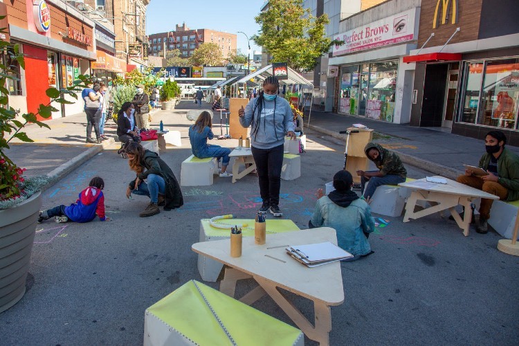 Children sitting on plaza in an urban area