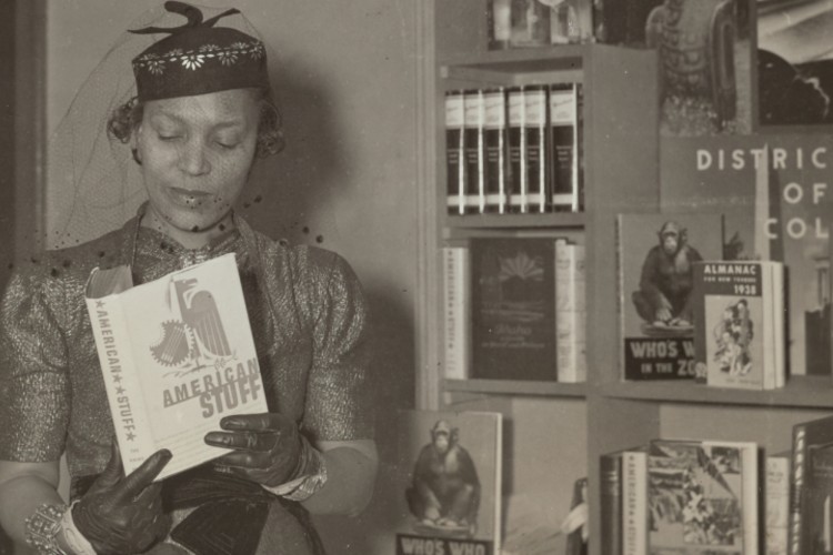 A historical photograph of a woman wearing a hat reading "American Stuff."