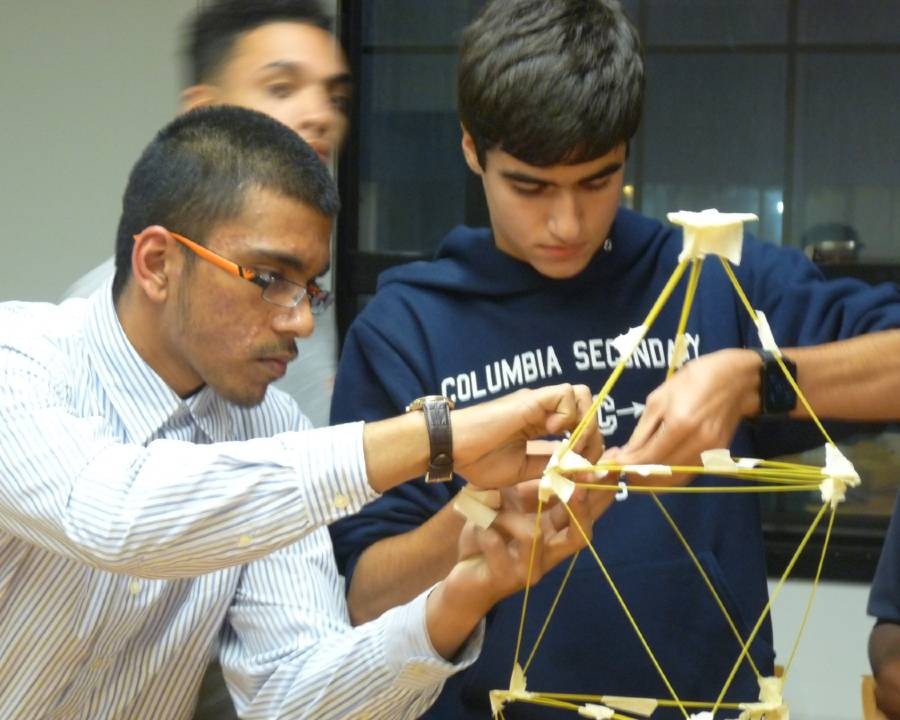 High school students from the Columbia Manhattanville ACE Mentorship team constructing a structure using spaghetti and masking tape during an activity that introduced them to basic principles of design and engineering. Students were competing to build the tallest structure that could balance a marshmallow at its peak.