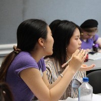 Two young women in a classroom.