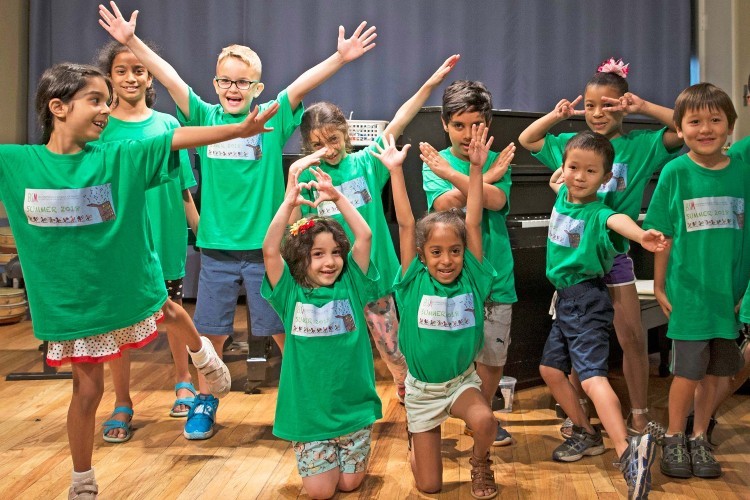 Students dance in front of a piano at the Bloomingdale School of Music in 2018.