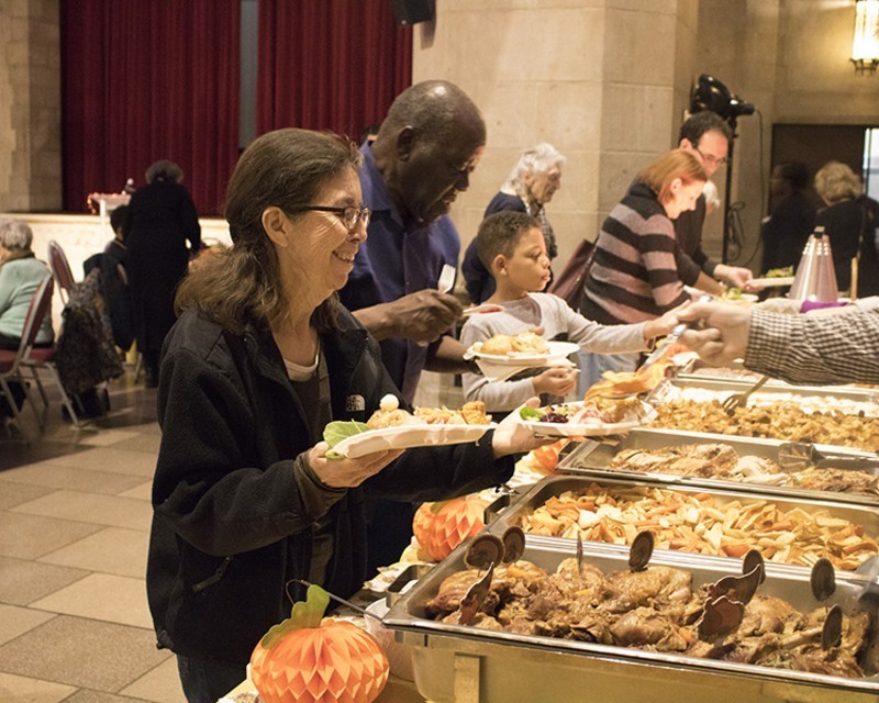 Smiling woman being served at the Senior Thanksgiving Luncheon at Riverside Church