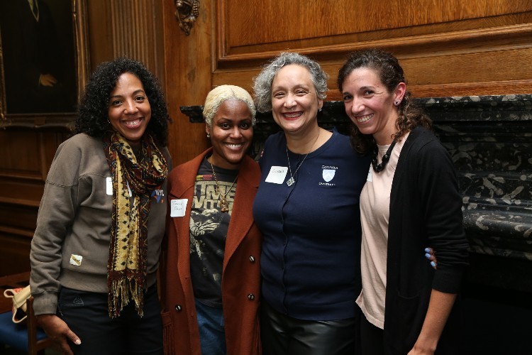 Four women smile at the camera