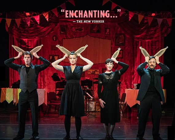 Four adults dressed in black with tan artificial bunny ears they're holding on their heads. The text "Enchanting" attributed to The New Yorker.