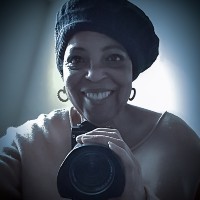 A picture of Celeste Lacy Davis holding a camera.