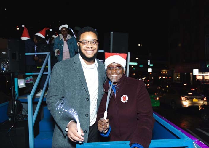 It was all smiles on the Columbia float at the Harlem Holiday Lights Parade. Photo by Kevin Dale Photography. Two riders on the Columbia flight with glow sticks.