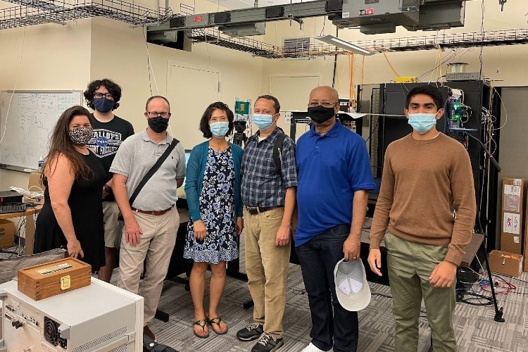 Teachers from the COSMOS program visit the Sandbox in the Columbia Electrical Engineering Department. Pictured from left to right are Genieve Fleming, Manav Kohli, Kristian Breton, Martina Choi, Jason Econome, Richard Foster, and Abhishek Adhikari. A group of adults standing in front of a large computer box.