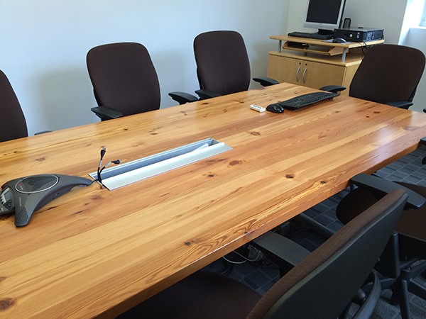 A conference table in use at Columbia constructed from reclaimed long leaf pine that was preserved during demolition at the Manhattanville Development site.