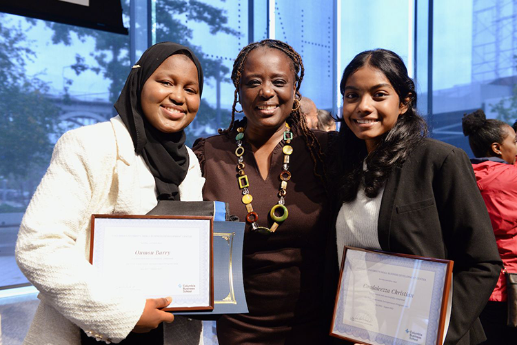 New York State Senator Cordell Cleare poses with two program graduates. Photo by Leslye Smith. Students pose with Senator Cleare after the ceremony.