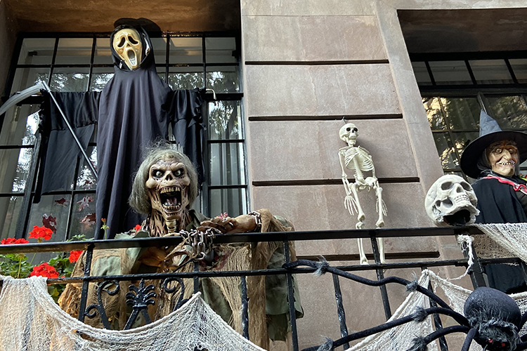 A balcony with skeleton and witch decor in uptown NYC.
