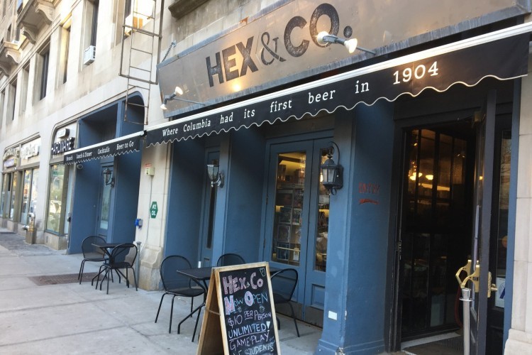 Hex & Co. storefront with awning and chalkboard sign on sidewalk.