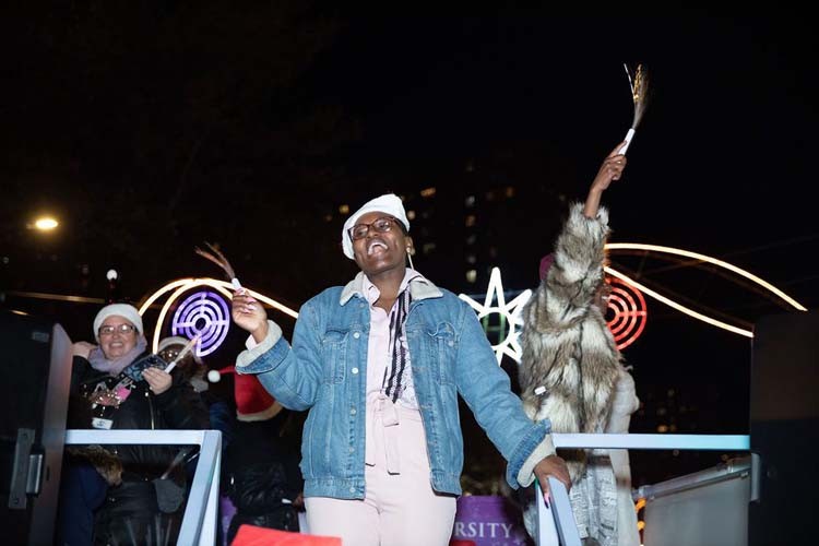 It was all laughs on the Columbia float at the Harlem Holiday Lights Parade on November 22, 2022. Photo by Kevin Dale Photography. Participants laugh on the Columbia float at the Harlem Holiday Lights Parade.