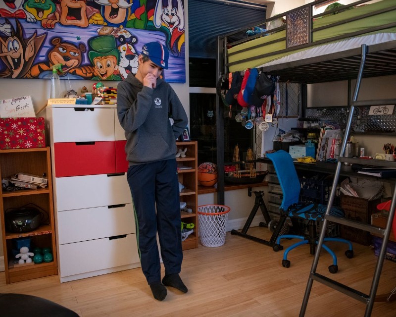 Child standing in a kids room.