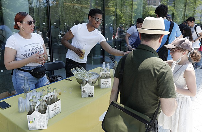 Uncle Waithley's Ginger Beer, a client of the Columbia-Harlem Small Business Development Center, handed out samples of the non-alcoholic drink. Photo by Lou Rocco. Uncle Waithley's staffers hand out samples.
