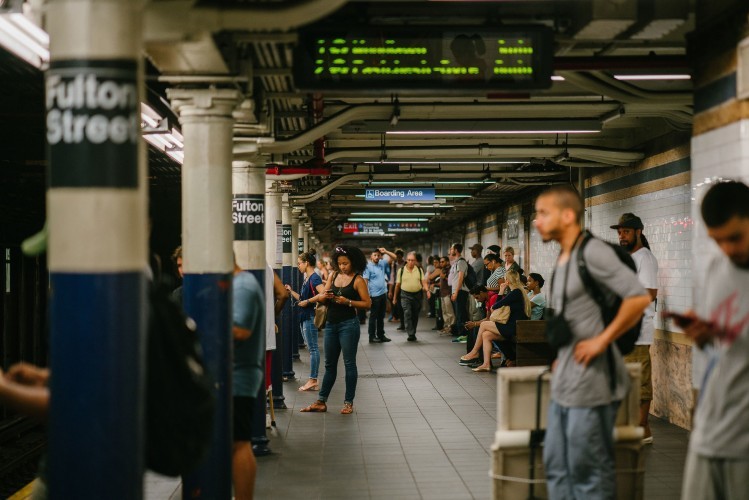 A photo from before the COVID-19 pandemic of a busy subway platform at Fulton Street.