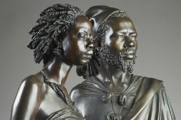 Metal busts of a man and a woman.