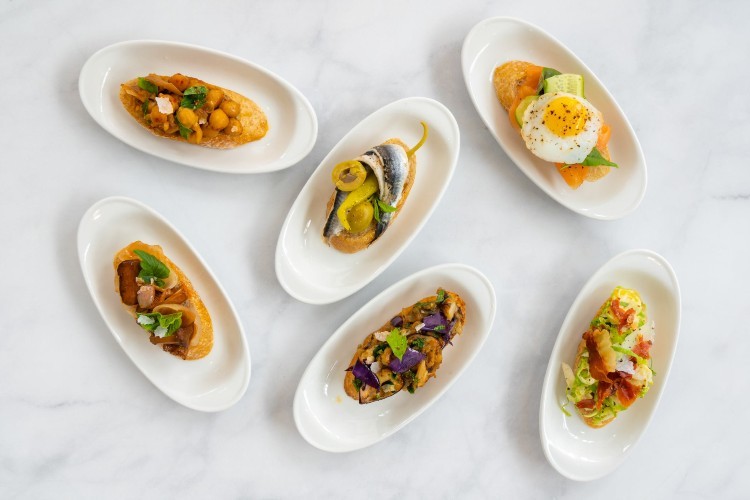 Several small plates holding Spanish food available at Olivia.