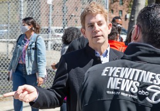 WABC-TV interviews Prof. Muennig. A man speaks to a reporter.