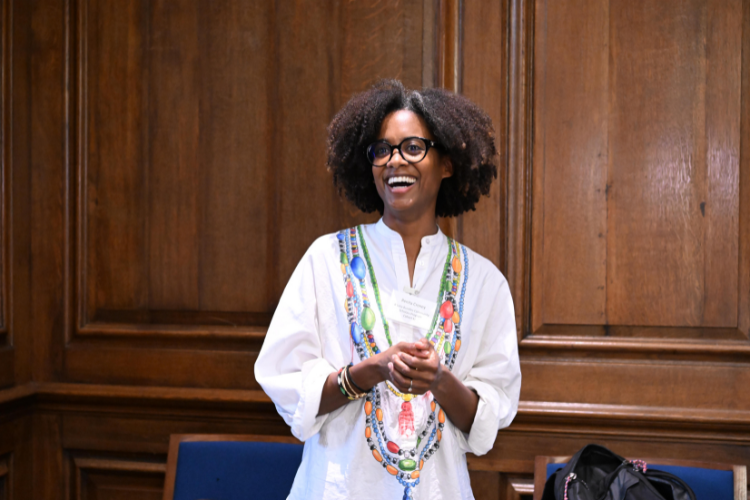 A woman laughs while speaking to the crowd. 