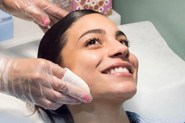 Woman receiving a facial at spa