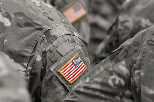 A flag on a veterans camouflage uniform. 