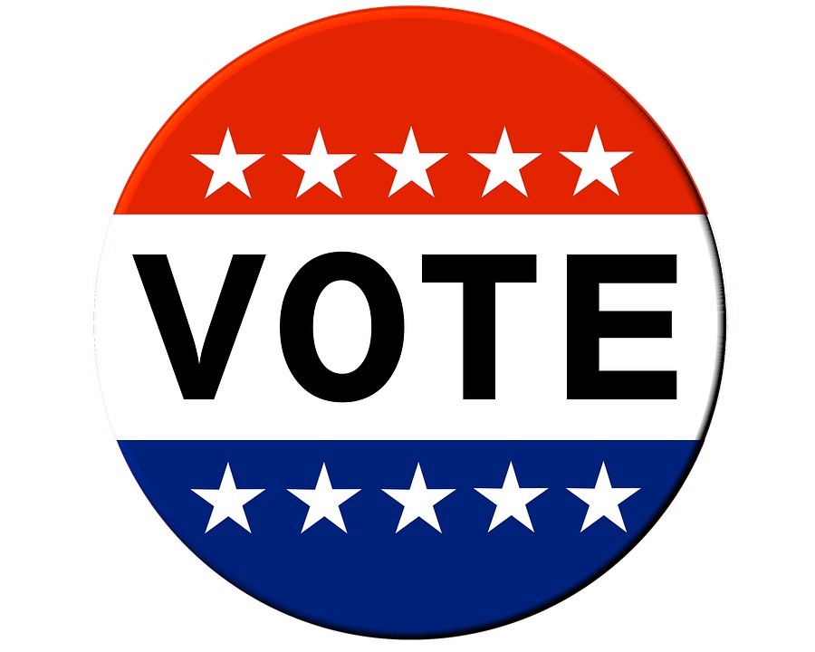 An image of a button that says "Vote" with a band of red with white stars above it and blue with white stars below it.