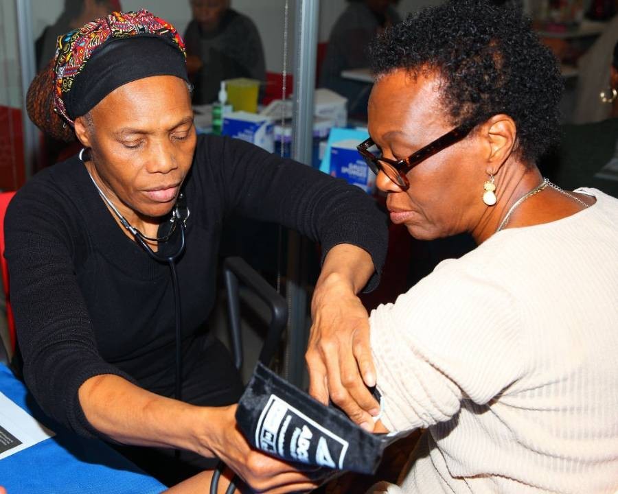 A health worker takes a community member’s blood pressure at the Community Wellness Center.