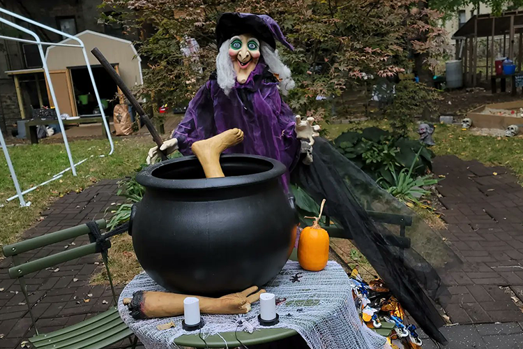 A decorative witch boils a plastic foot.