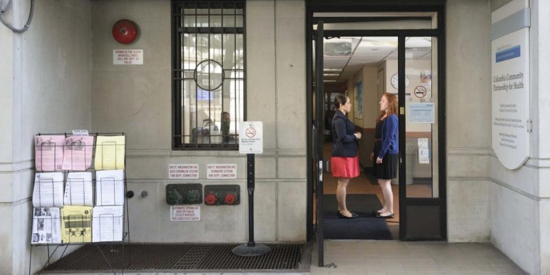 Two women speaking in front of the Columbia University Irving Medical Center