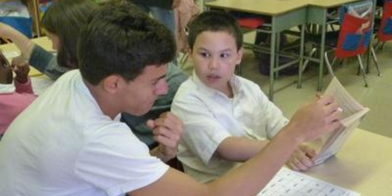 A Mentor helping a child read. 
