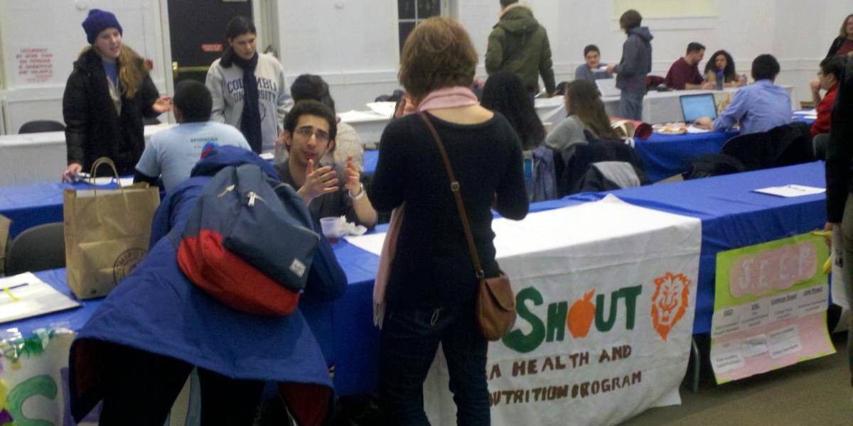 Student volunteer talks with a participant.